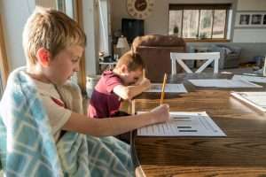 boys doing schoolwork at home