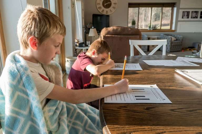 boys doing schoolwork at home