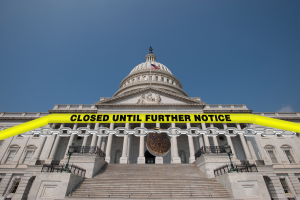 Government building with sign saying "Closed until further notice"