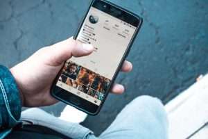 Person using social media on a smart phone.