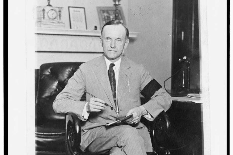 A seated Calvin Coolidge, the president who prioritized small government and economic restraint.