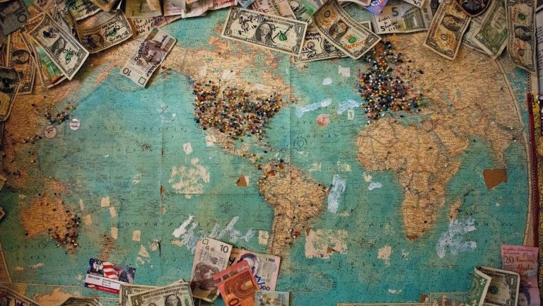 Map of the world with pins in it marking different locations.
